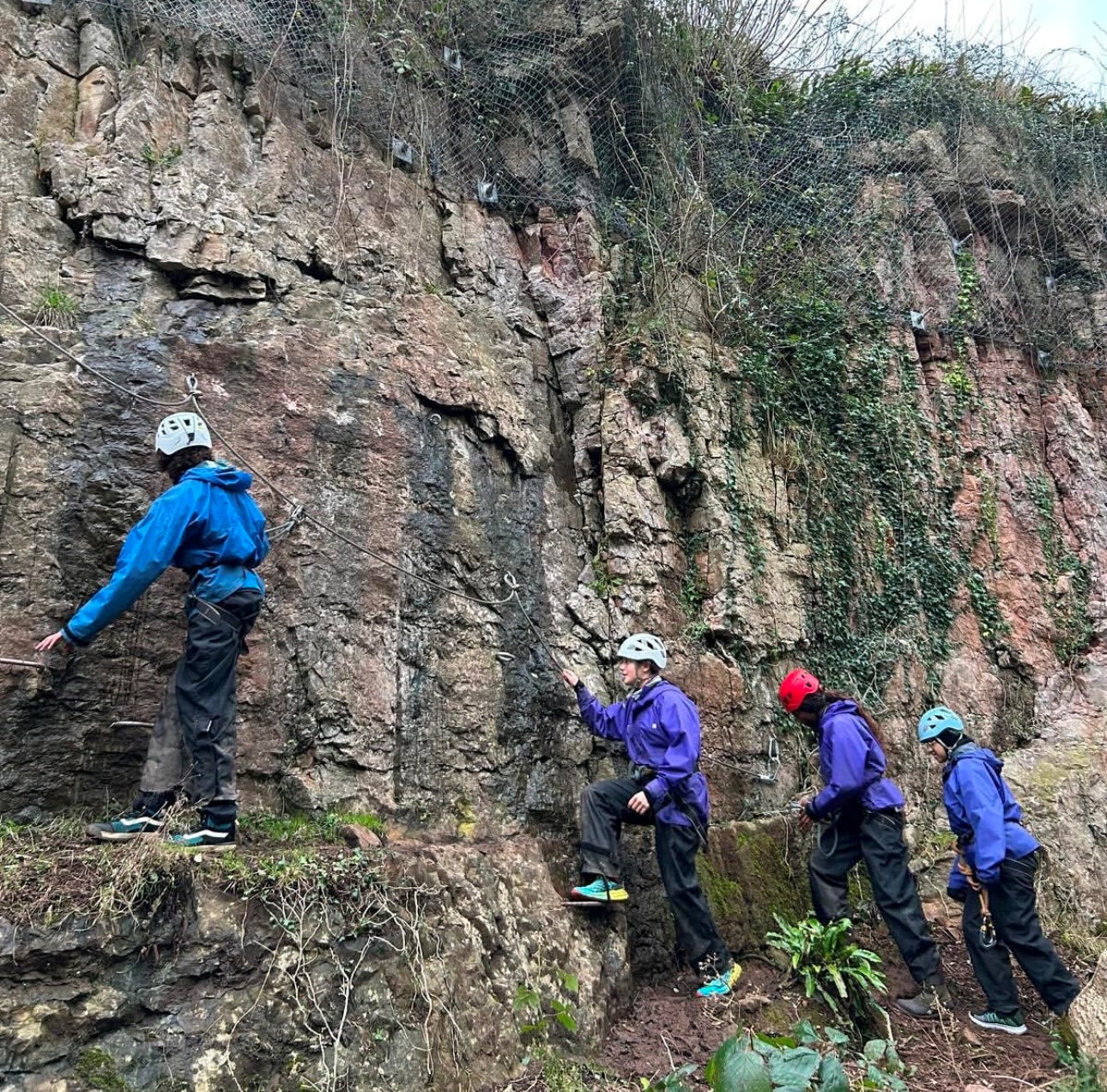Four students getting to grip with climbing