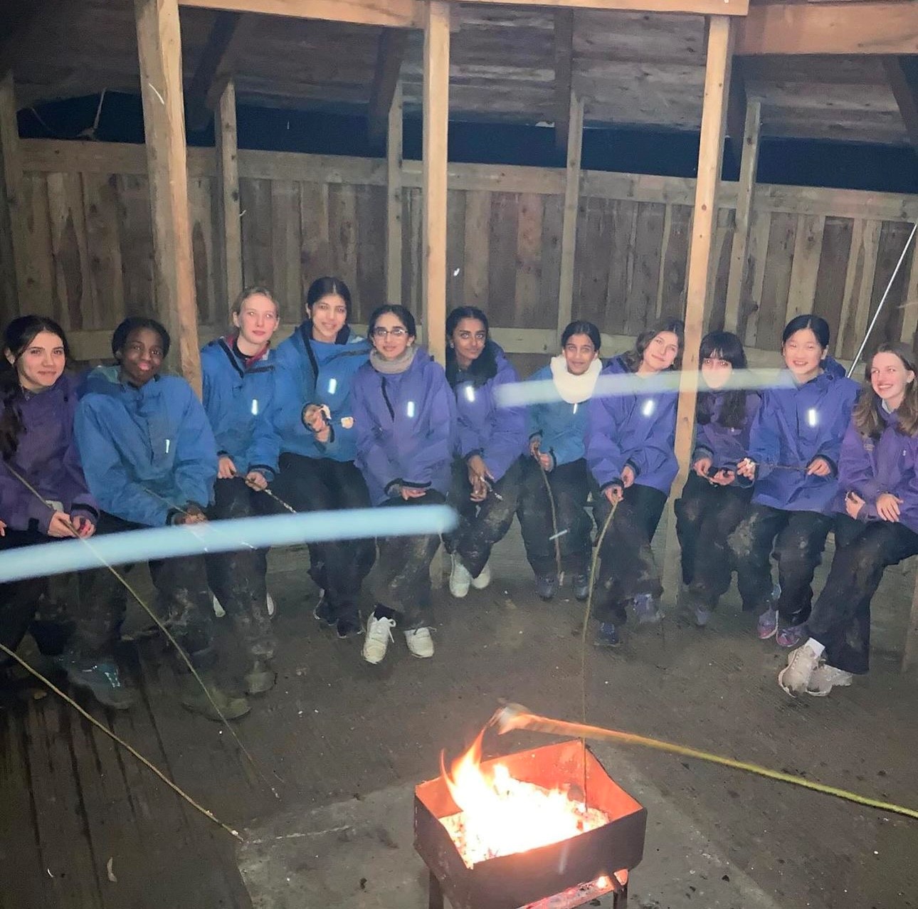 Eating marshmallows by a fire