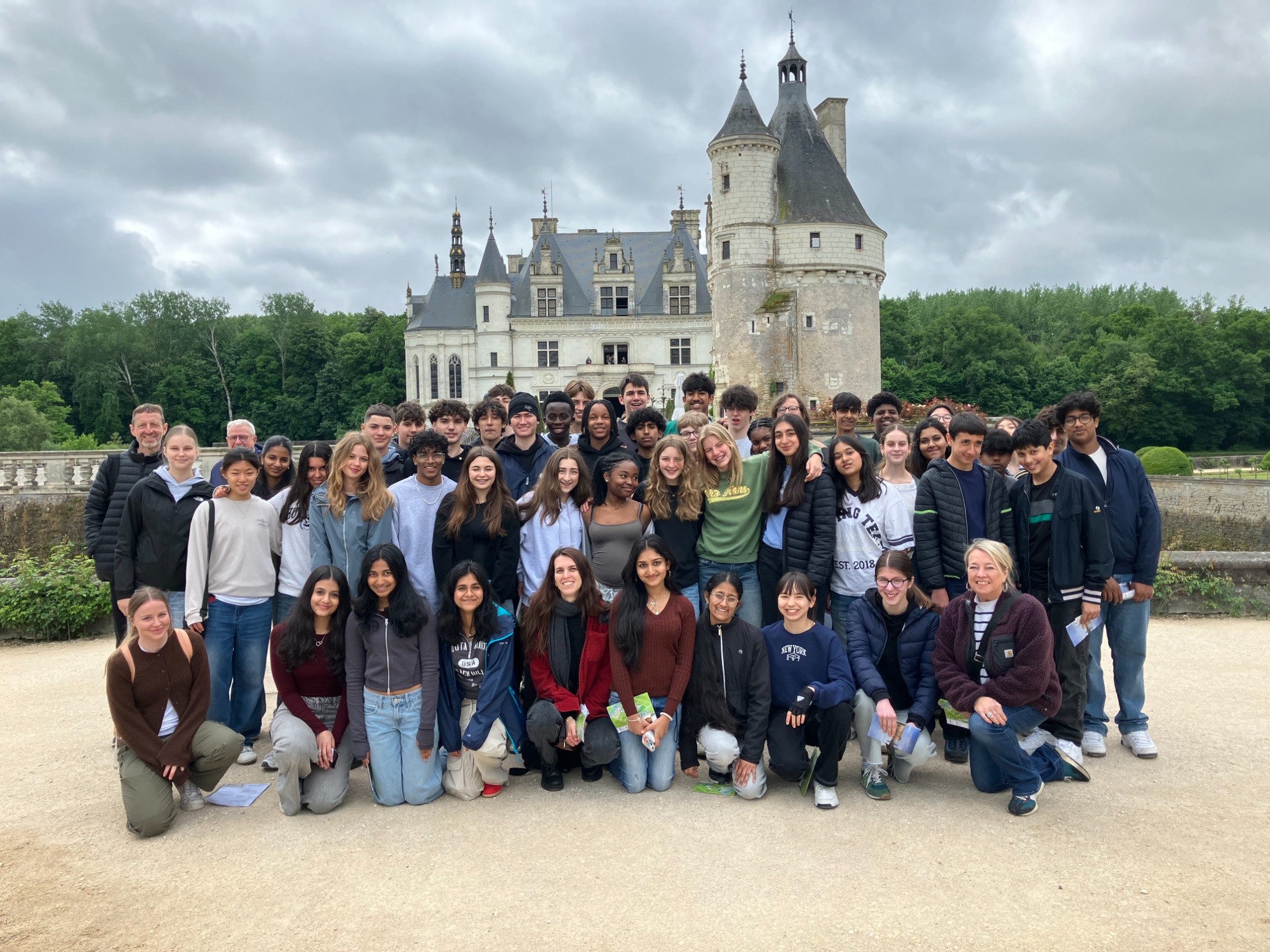 Group of students posing in front of a castle