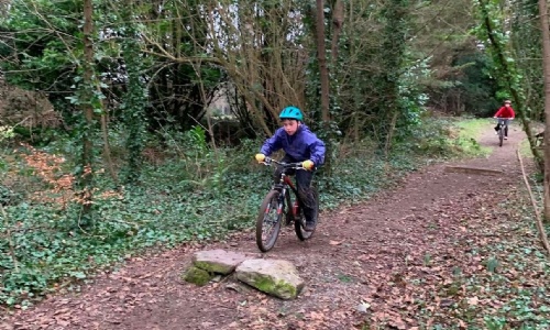 Year 7 student cycling on dirt path