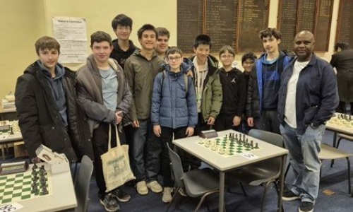 Latymer Chess team posing, along with the teacher supervising the club