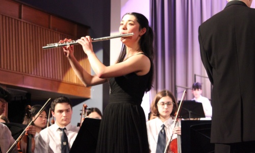 Student playing the flute during the concert