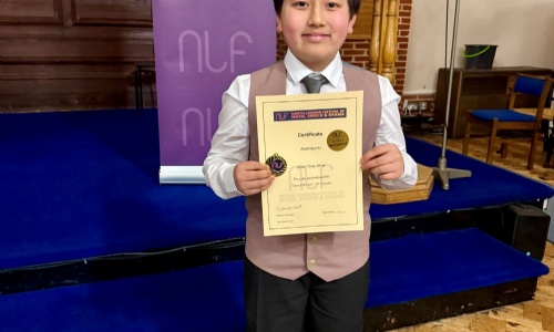 Max posing with his winning certificate