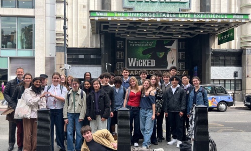 Year 10 students and teachers in front of the Wicked Theatre