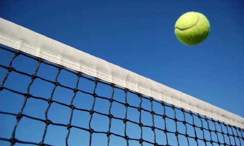 Tennis ball being thrown in the air