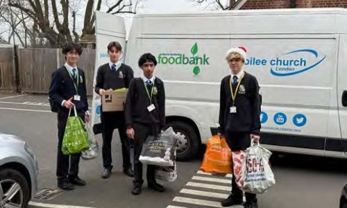 Students bringing bags of food to the food bank's truck
