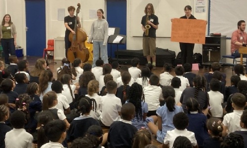 Latymer students in front of young pupils