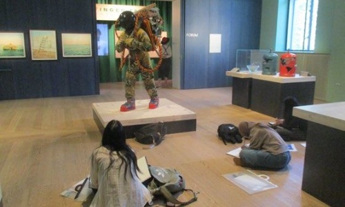 Students sketching a scultpure