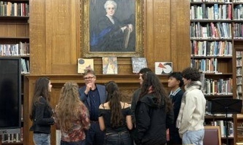 James Butterwick surrounded by students