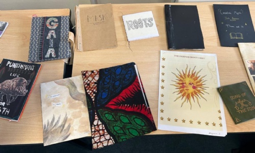 Covers of different poems on a table