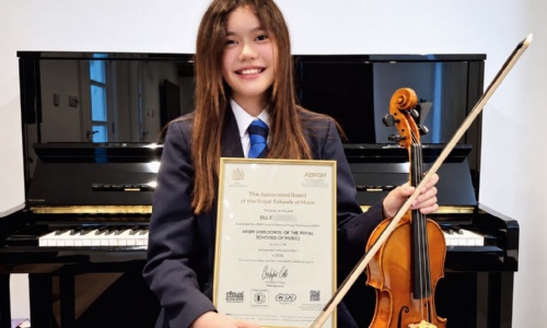 Ellie posing with her award and violin